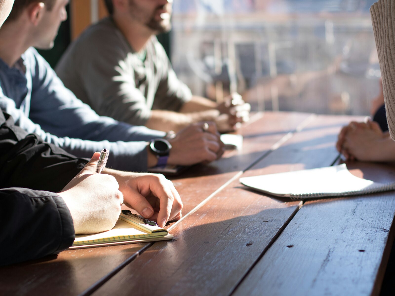 A small team taking notes together during a meeting