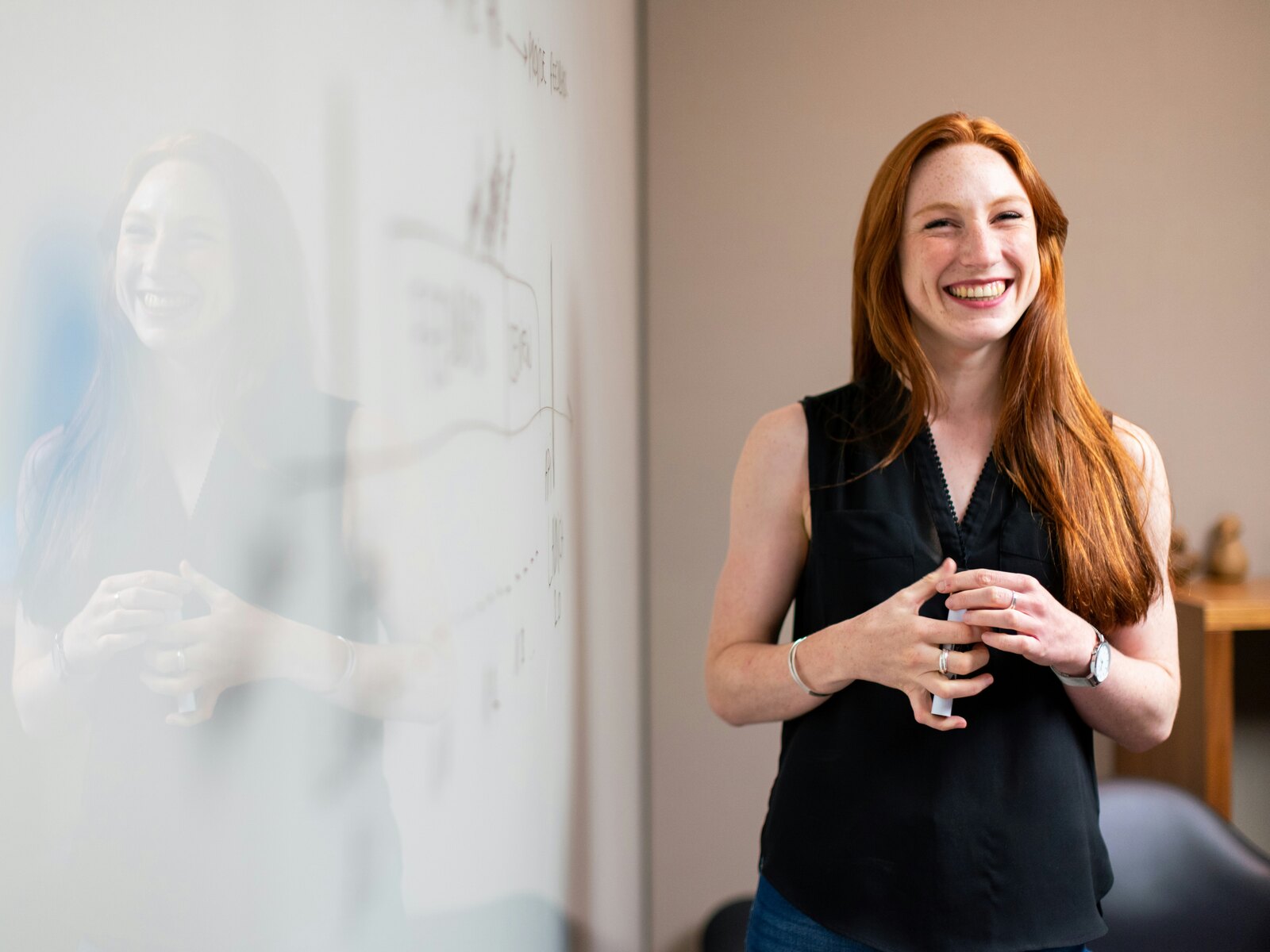 A school leader talking through a plan in front of a whiteboard